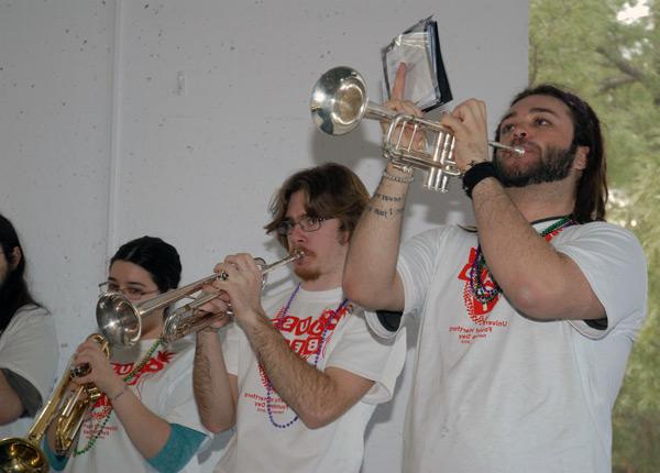 Three students playing trumpets
