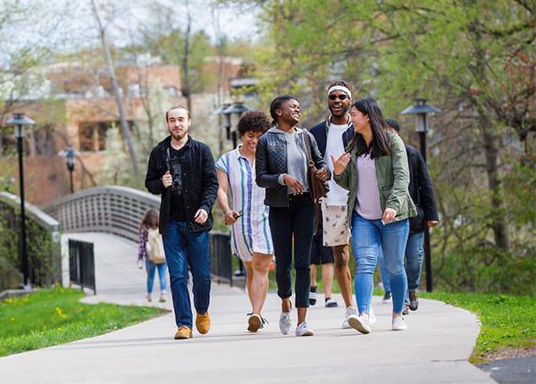 students walking over bridge